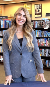 A picture of Dr. Kimberly Regan at her book signing for Unbroken: Road to Freedom