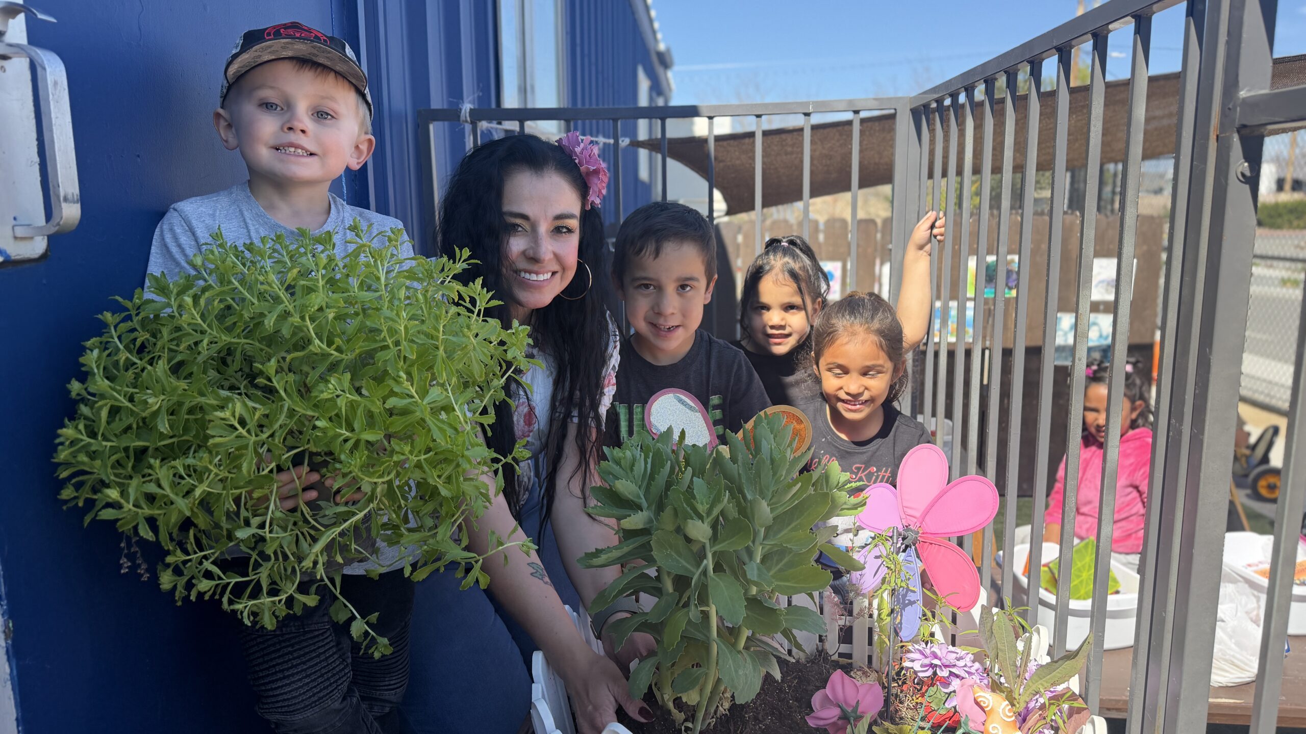 Pre-K students participating in outdoor, hands-on learning with their teacher at SNACS, a tuition-free K–8 charter school.